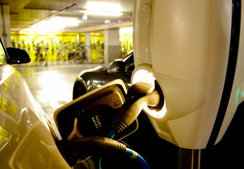 Close up of an electric vehicle plugged into an EVBox BusinessLine charging station