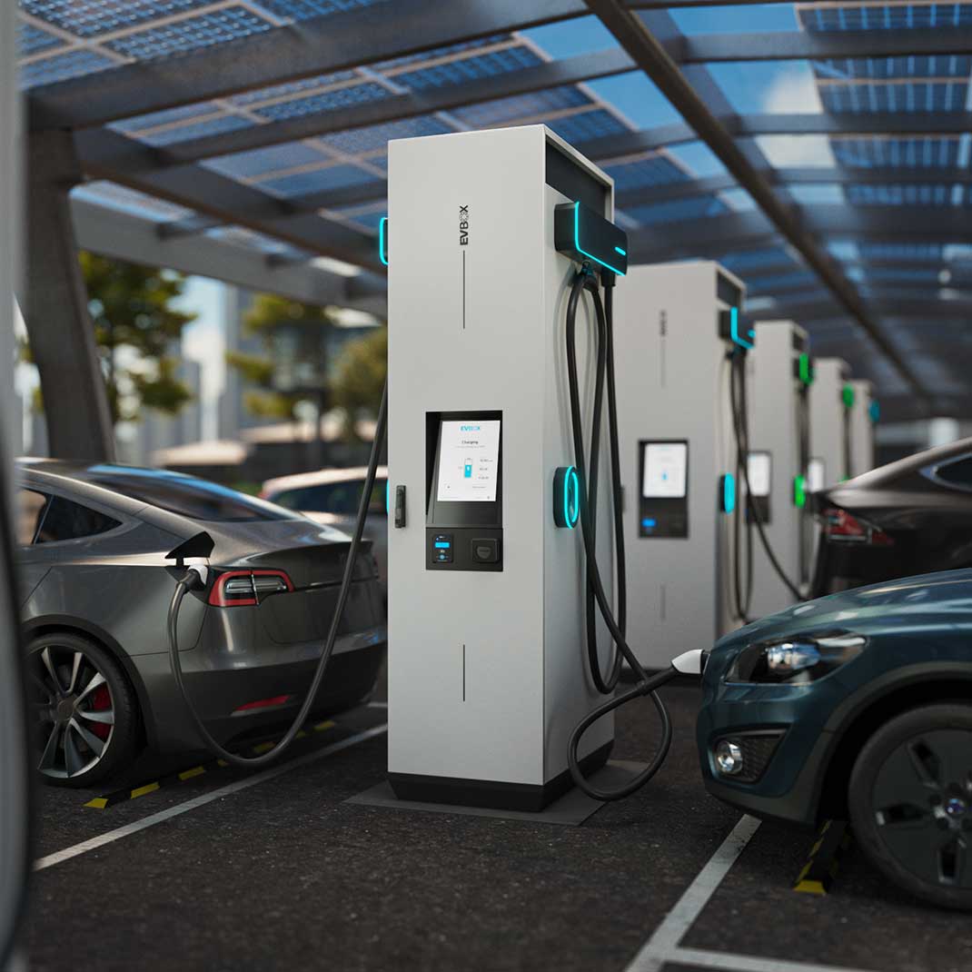 Une rangée de stations de recharge modulaires EVBox Troniq chargeant des voitures électriques dans un parking