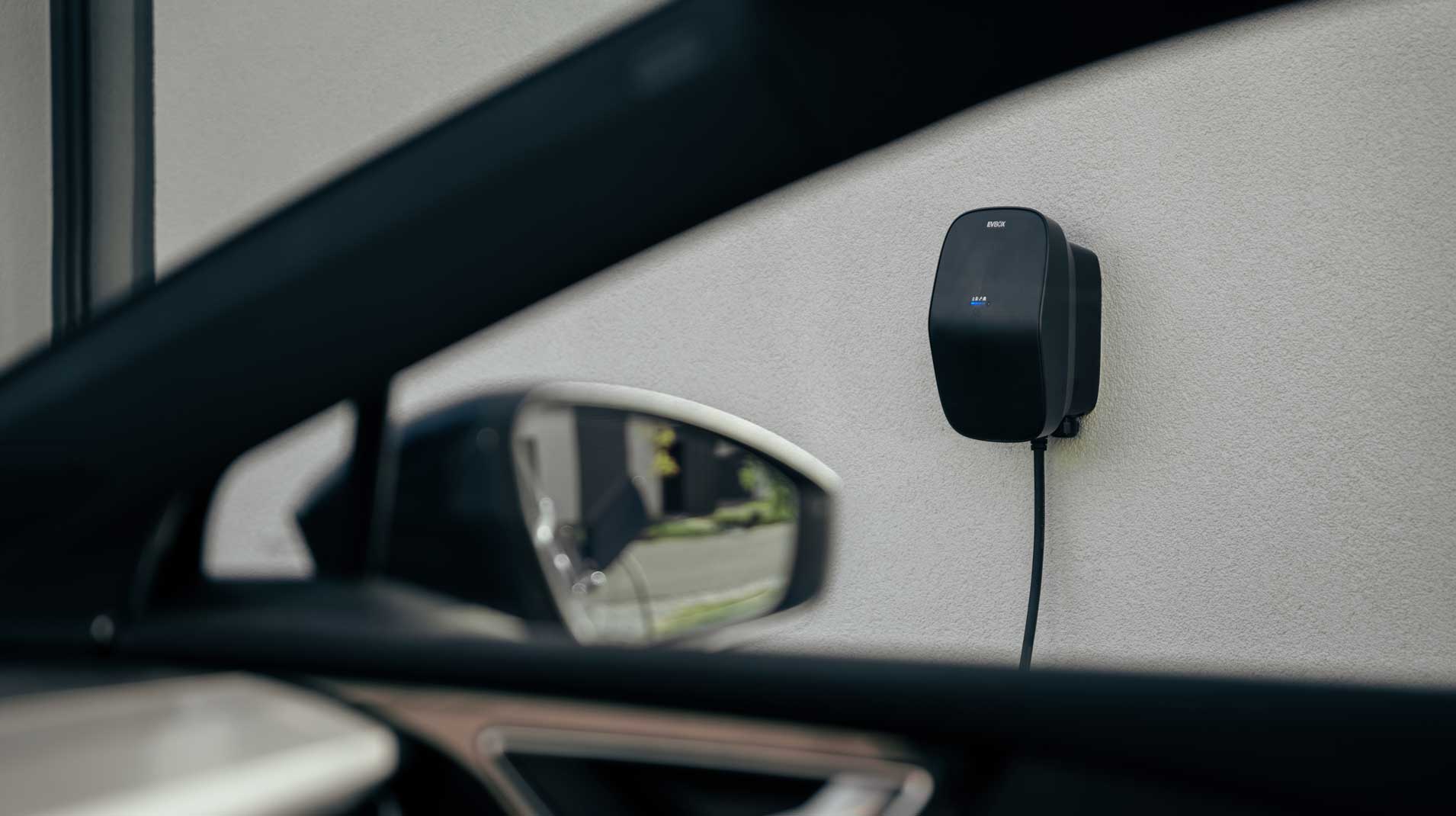 A view of the EVBox Livo cable charger through the right hand window on a car.