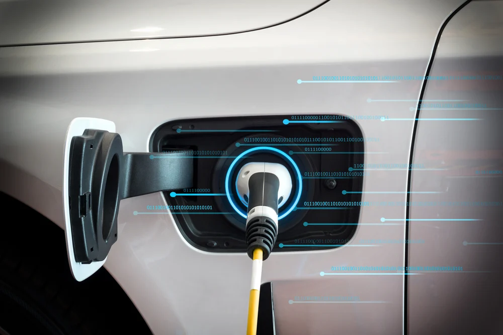 A electric car charging with a blue visualization of data flows.
