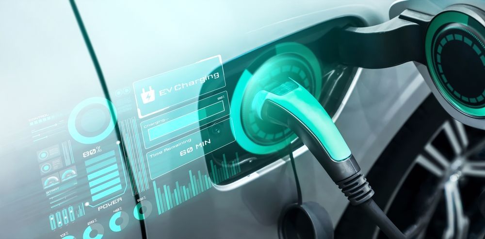 An EV charger connected to an electric car and a hologram showing detailed insights of the charging session.