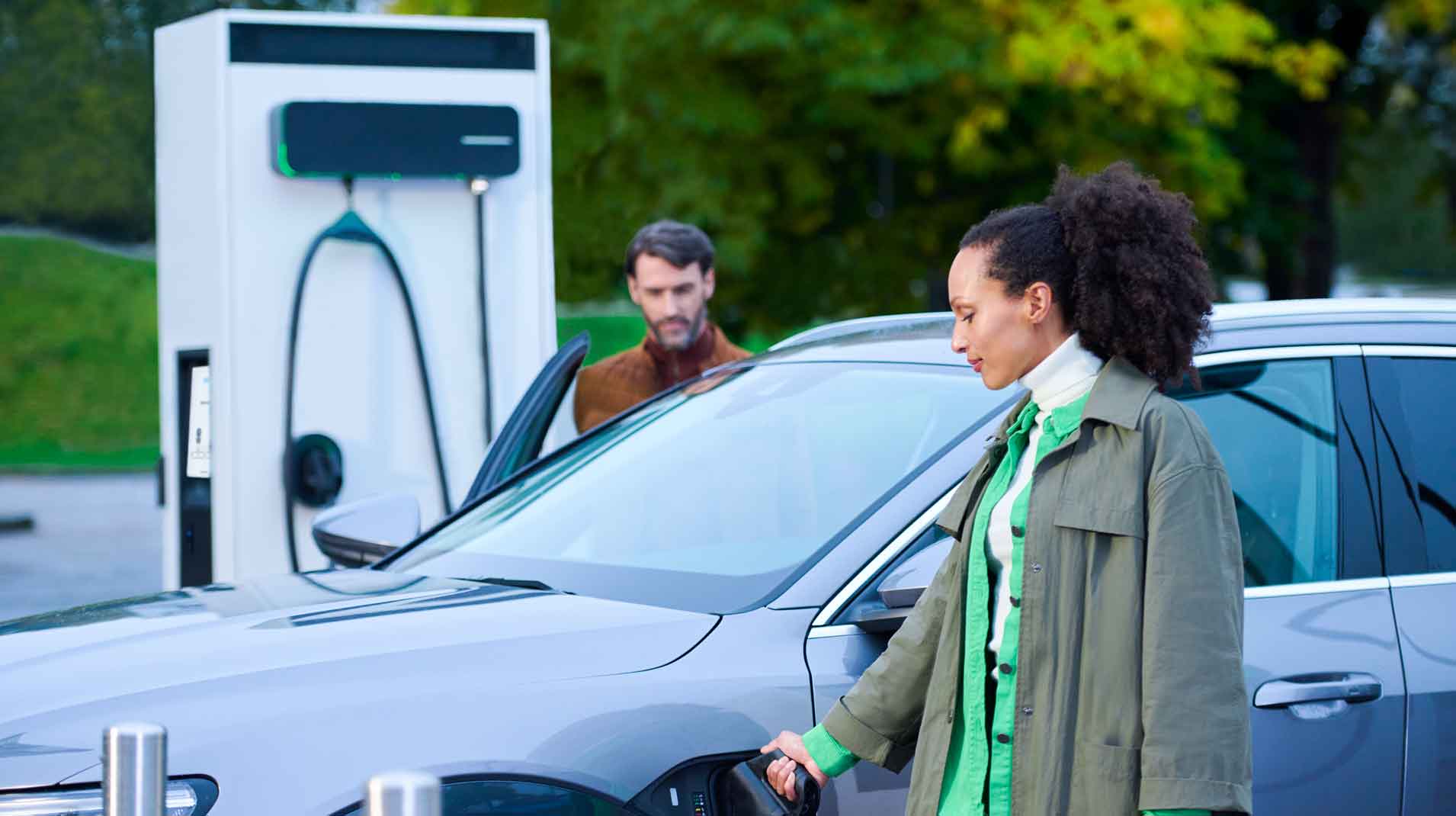 Woman charging her electric car with EVBox Troniq Modular