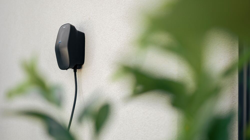 An EVbox Livo home charger mounted on a wall.