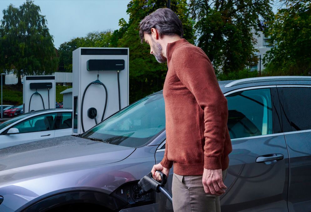 Man charging car using EVBox Troniq Modular DC charger.