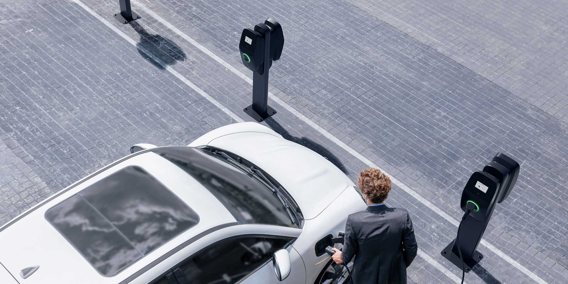 Man in suit using EVBox Liviqo charging station