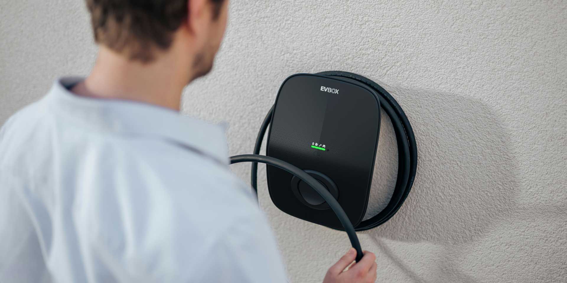A Level 2 AC home charging station, EVBox Livo, mounted to a wall.