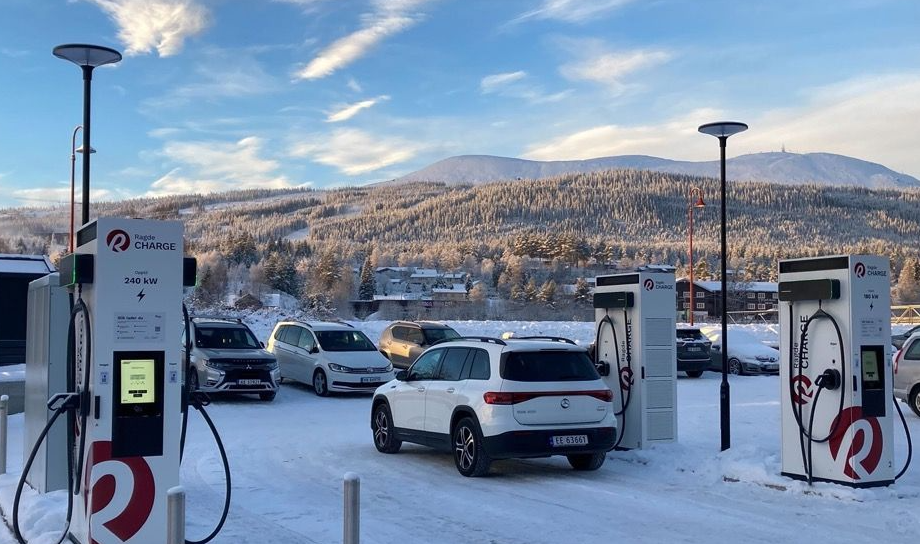 Charging stations in the snow in Norway with mountains in the background