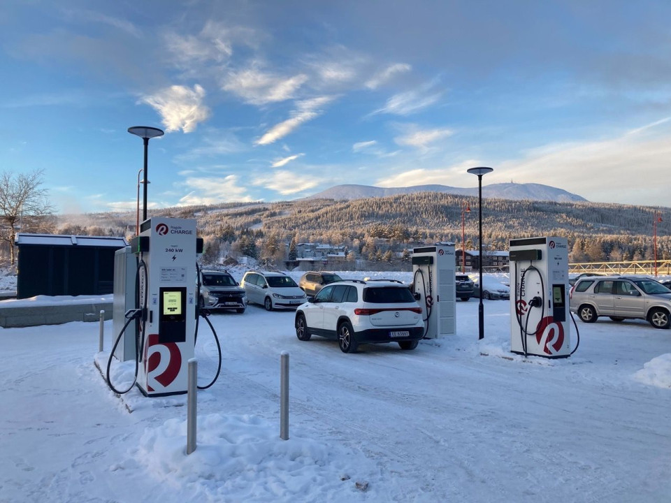 Car charging with an EVBox charging station in a snowy parking lot