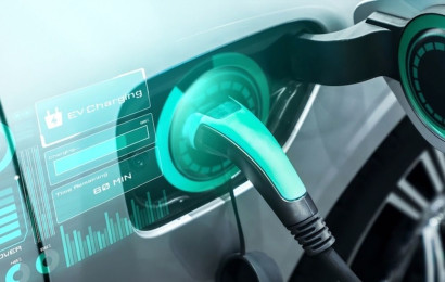 A futuristic photo of a charging cable connected to an electric car. An infographic shows that the car is charging.