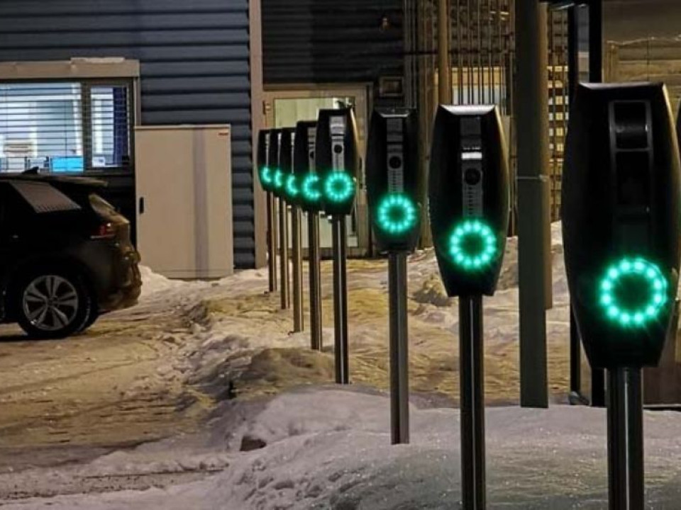 A row of EVBox BusinessLine charging stations in the snow