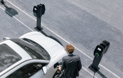 Bird's eye view of a man charging his electric vehicle