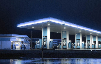 An empty and lit modern gas station at night.