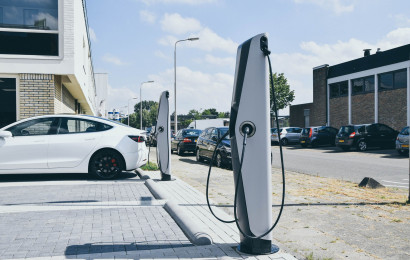 A corporate office's parking lot with two EVBox Troniq EV charging stations.