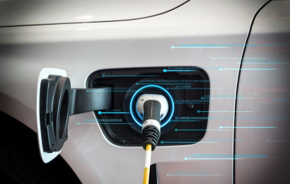 A futuristic photo of charging cable plugged in an electric car while showing charging data flowing.