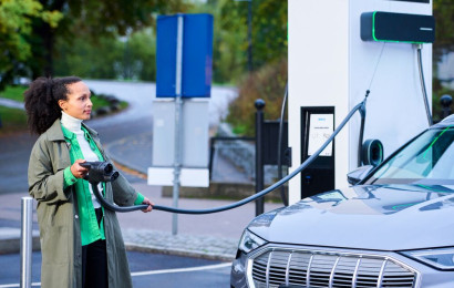 A woman is charging her EV using EVBox Troniq Modular